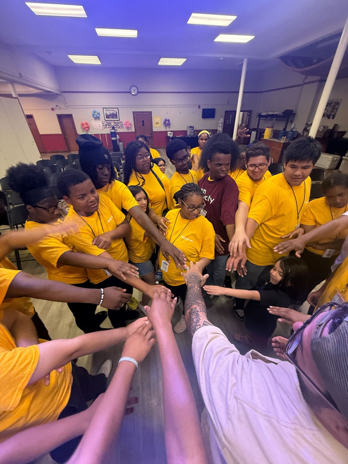 Teen Life interns putting their hands in together
